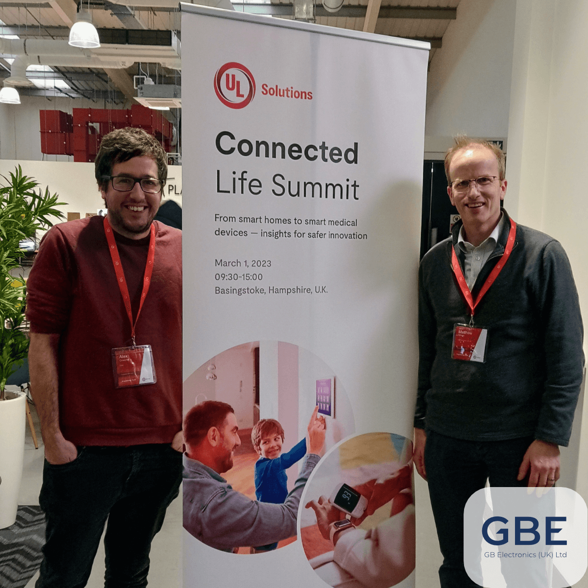 Senior staff from GB Electronics posing next to a Connected Life Summit 2023' pull-out banner.